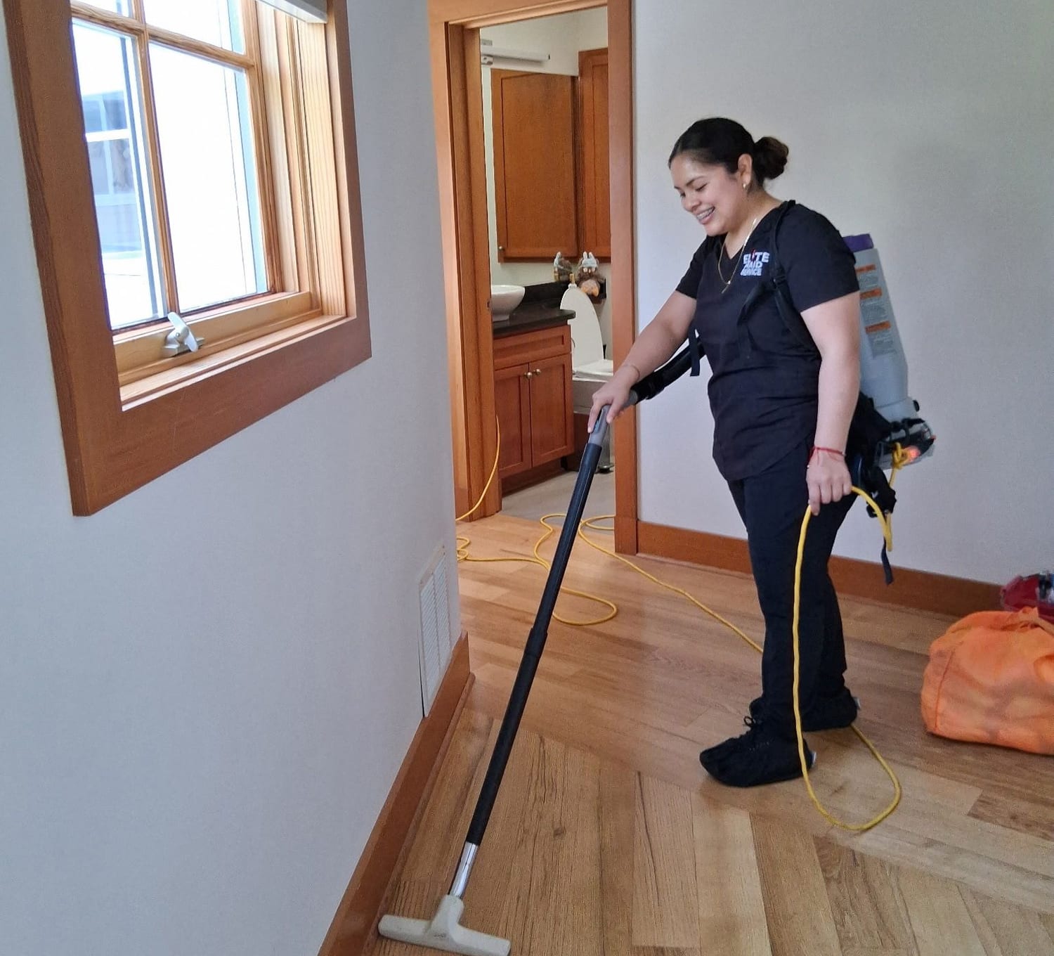 Elite Maid technician cleaning a home in the Greater Seattle area